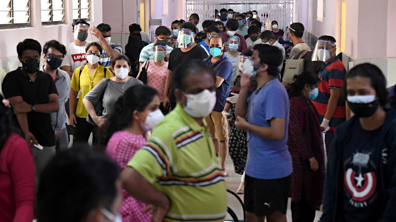 Several people wait to get the Covid vaccination at CV Raman General Hospital in Bengaluru. Credit: Dh Photo/Pushkar V