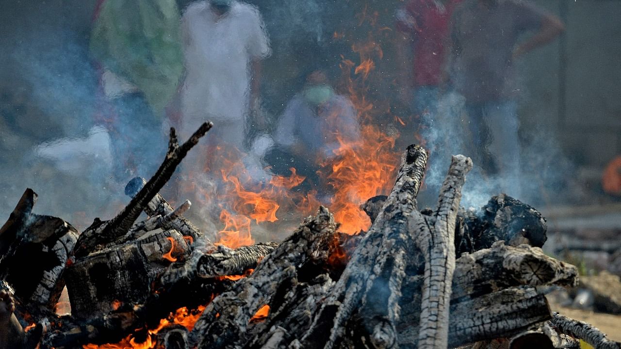 Burning funeral pyre of a patient who died of Covid-19 can be seen at a crematorium in New Delhi. Credit: AFP Photo