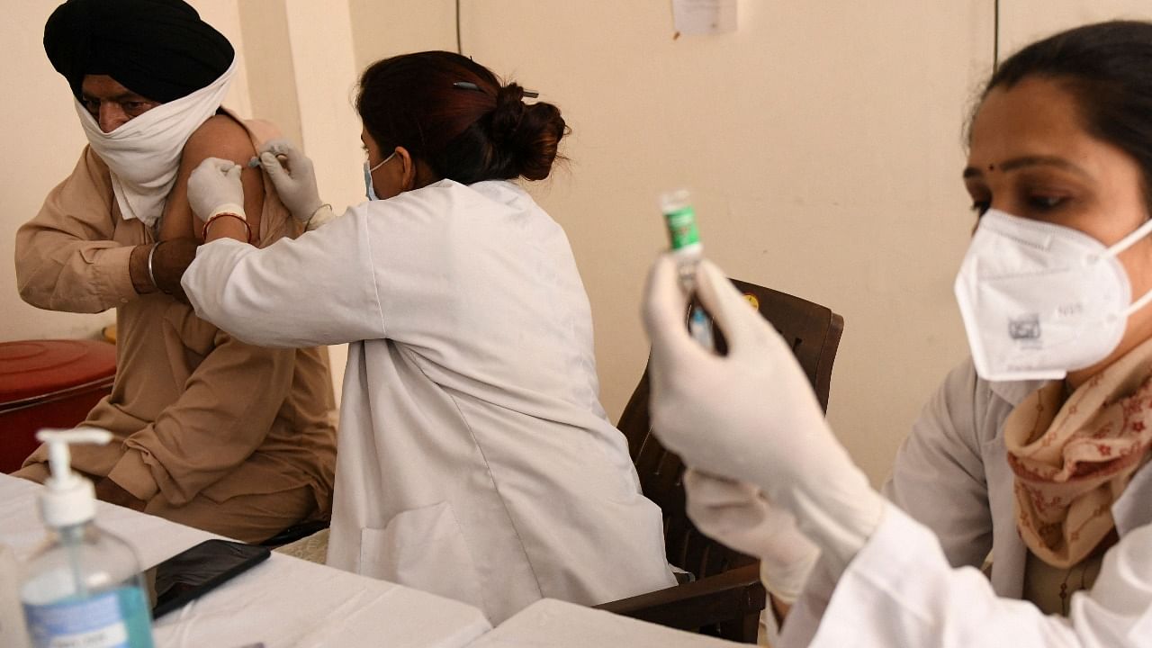 A medical worker inoculates a man with a dose of the Covishield Covid-19 coronavirus vaccine at a civil hospital in Amritsar. Credit: AFP Photo