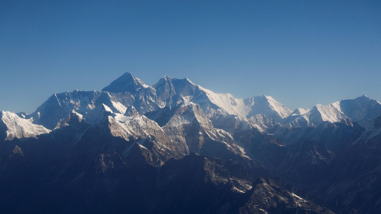 Mount Everest, the world highest peak, and other peaks of the Himalayan range are seen through an aircraft window during a mountain flight from Kathmandu. Credit: Reuters photo