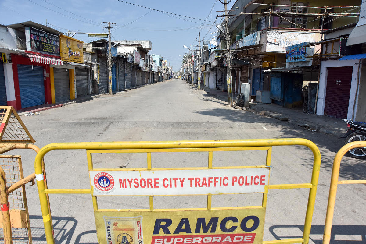Barricades erected on the road connecting Meena Bazaar in view of the lockdown in Mysuru. DH PHOTO