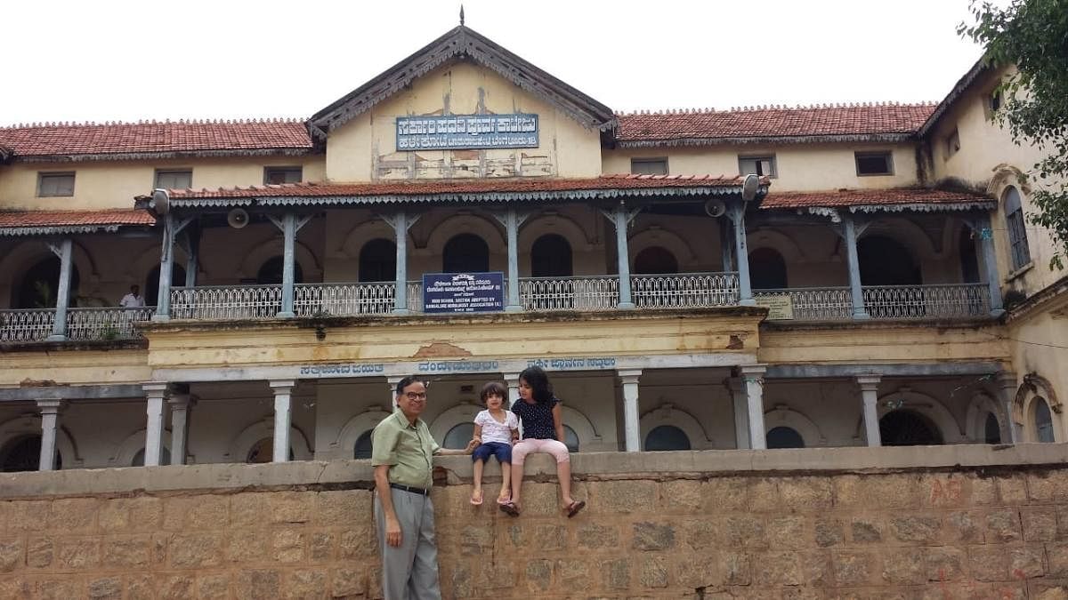 The author (M B Pranesh) with his grandchildren Tulasi and Vaishnavi at the Fort High School before it was taken over for renovation by INTACH