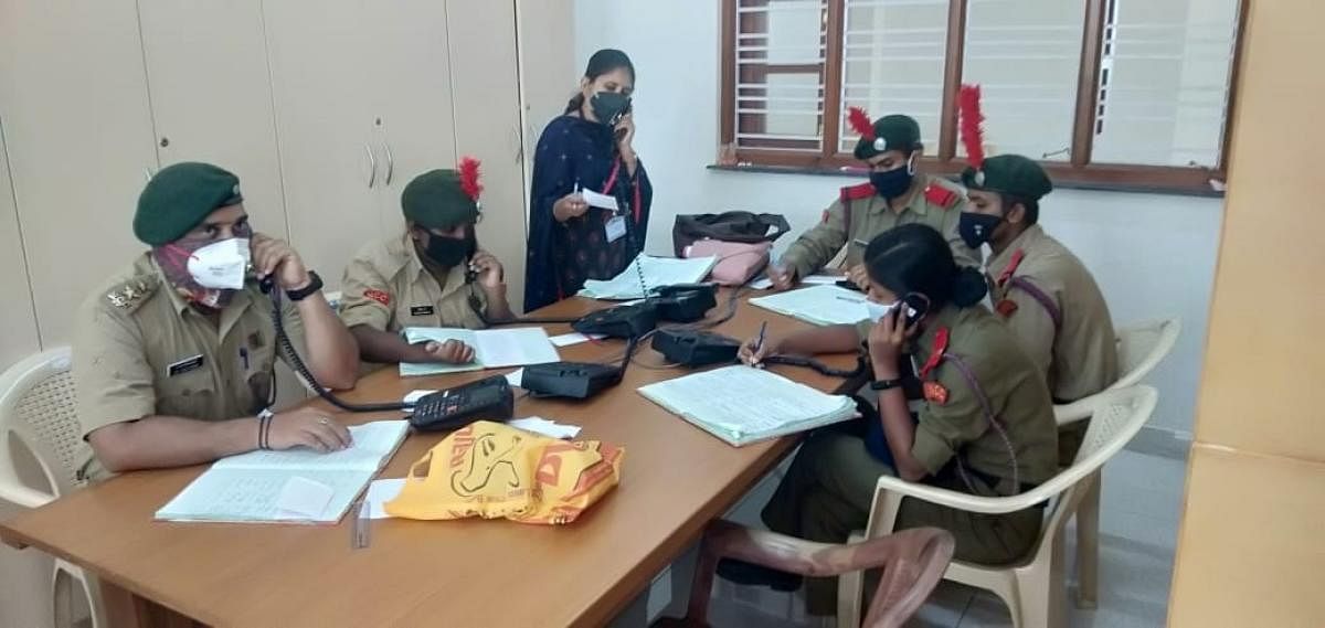 NCC Cadets man the helpline in the Covid War Room in Mysuru. DH Photo