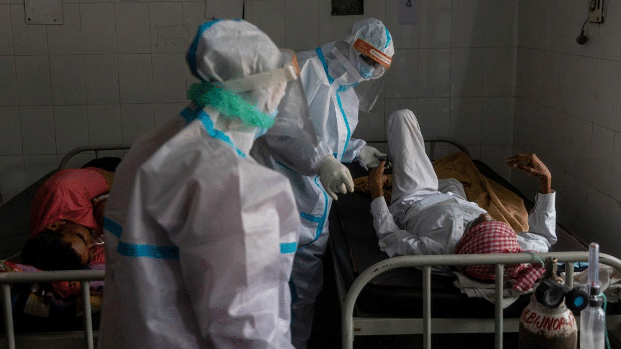 Medics tend to a man with breathing problems inside a Covid-19 ward of a government-run hospital. Credit: Reuters Photo