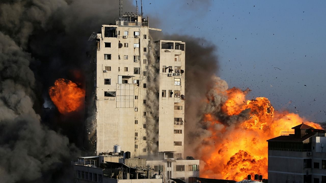 Smoke and flames rise from a tower building as it is destroyed by Israeli air strikes amid a flare-up of Israeli-Palestinian violence, in Gaza City. Credit: Reuters Photo