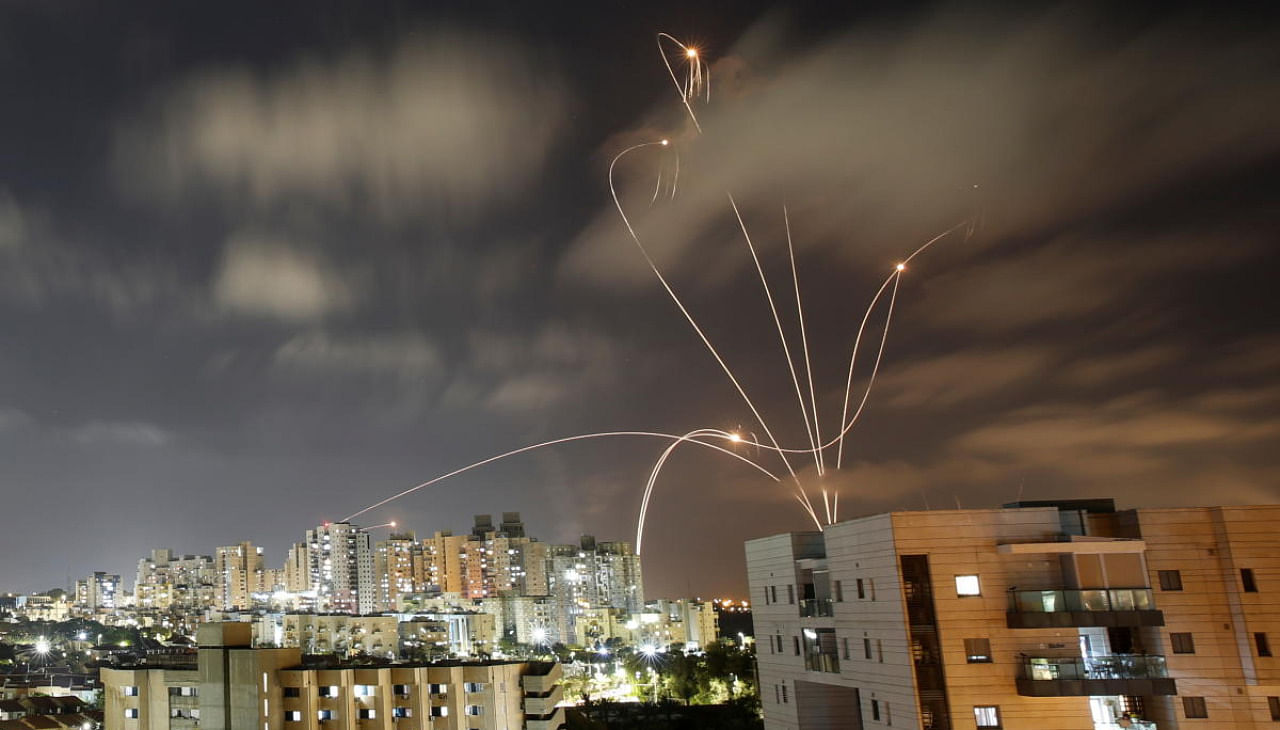 Streaks of light are seen in Ashkelon as Israel's Iron Dome anti-missile system intercepts rockets on Wednesday night. Credit: Reuters