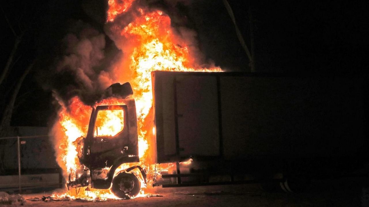 A truck burns at the entrance of the mixed Jewish-Arab city of Lod, where a state of emergency has been declared following civil unrest, on May 12, 2021.  Credit: AFP Photo