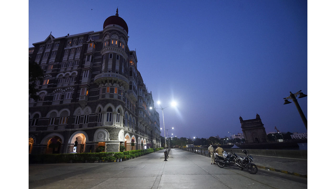 City streets near Taj Hotel wear a deserted look during weekend lockdown, imposed to curb the surge in coronavirus cases in Mumbai. Credit: PTI