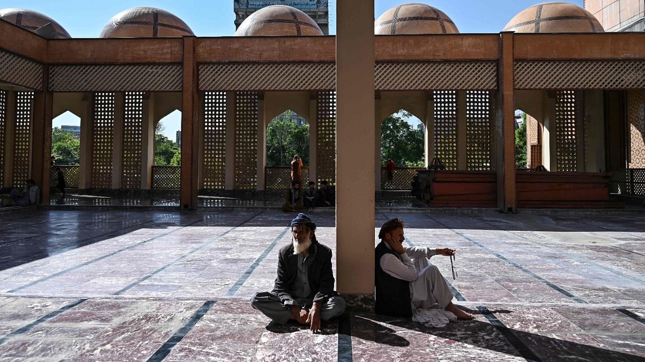 Muslim devotees arrived at the Abdul Rahman Mosque to start the Eid-al-Fitr festival marking the end of the Islamic holy fasting month of Ramadan during a three-day ceasefire agreed by the warring Taliban and Afghan forces, in Kabul on May 13, 2021. Credit: AFP Photo