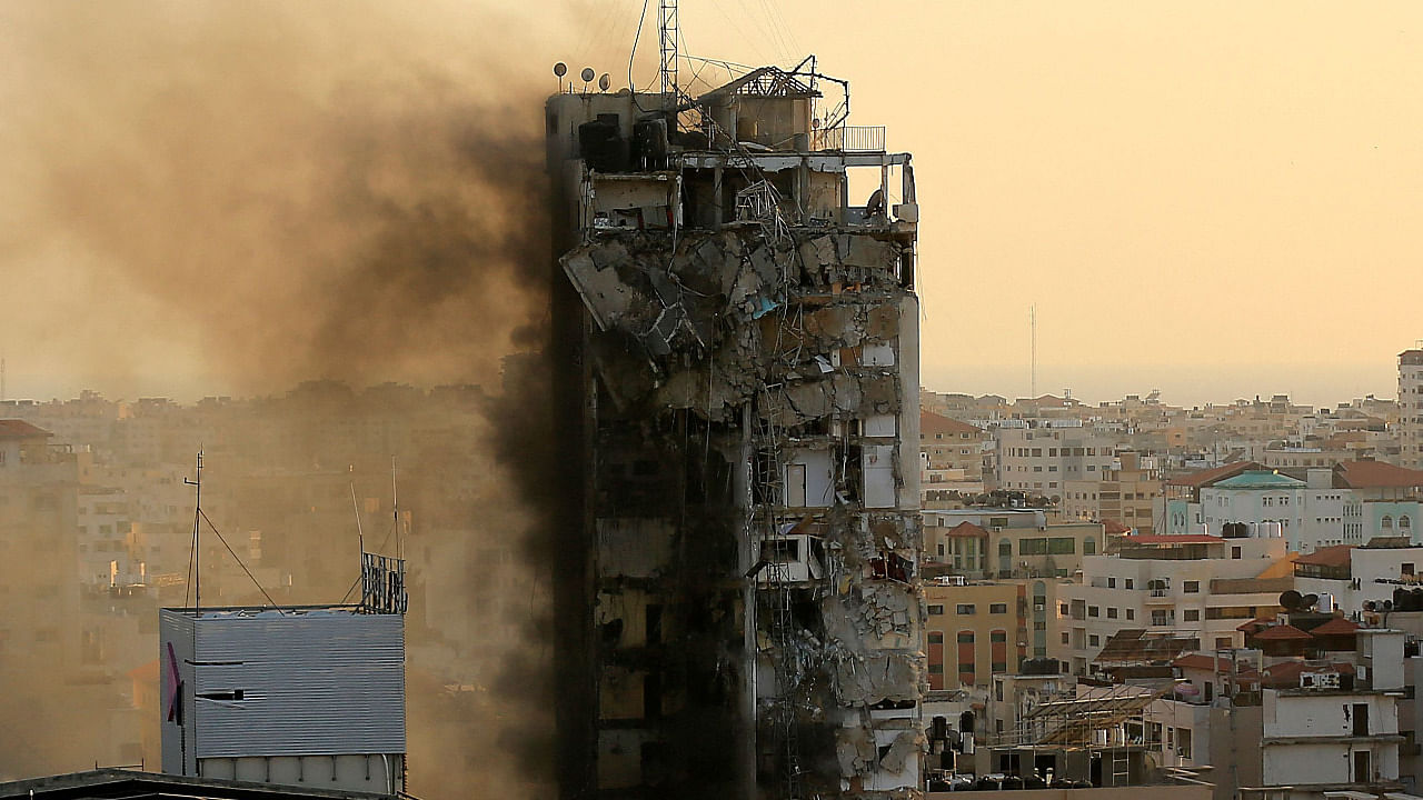 An air guided bomb can be seen hitting Al-Sharouk tower as it collapses during an Israeli air strike, in Gaza City. Credit: AFP Photo