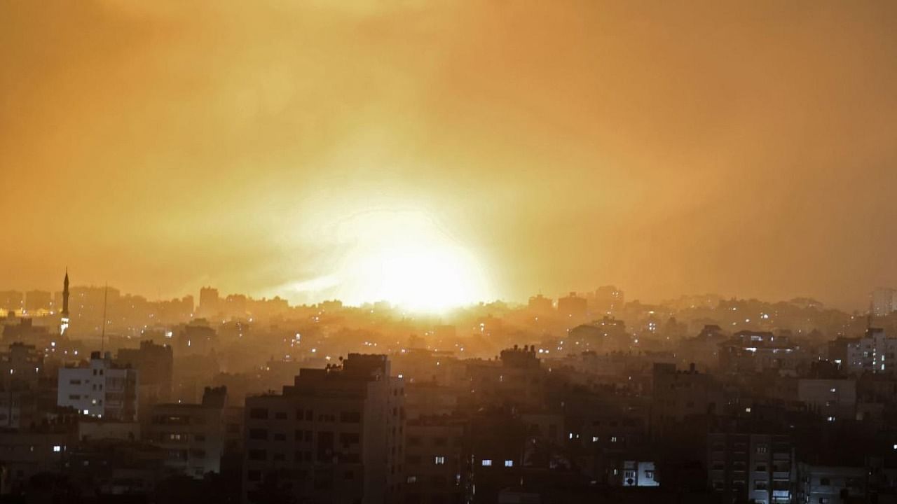 An explosion lights the sky following an Israeli air strike on Beit Lahia in the northern Gaza Strip. Credit: AFP Photo