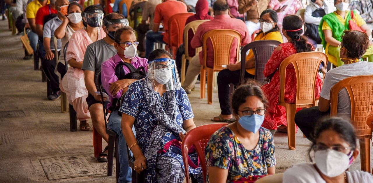 Citizens stand in a queue as they wait to be vaccinated in Mumbai. Credit: PTI Photo