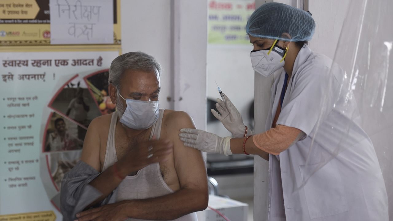 A medic administers Covid-19 vaccine dose to a beneficiary, at a vaccination centre, in Ghaziabad, Friday, May 14, 2021. Credit: PTI Photo