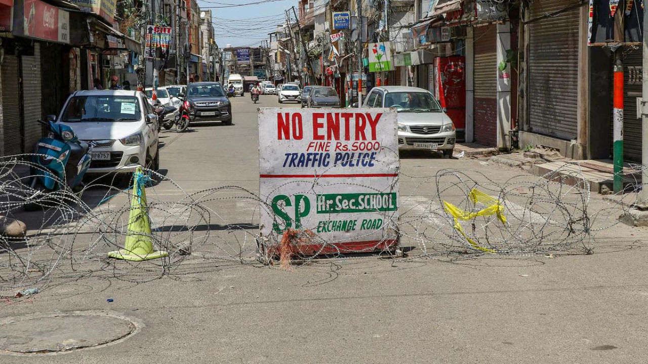 Makeshift temporary barricade at a market area during Covid-induced lockdown, in Jammu. Credit: PTI Photo