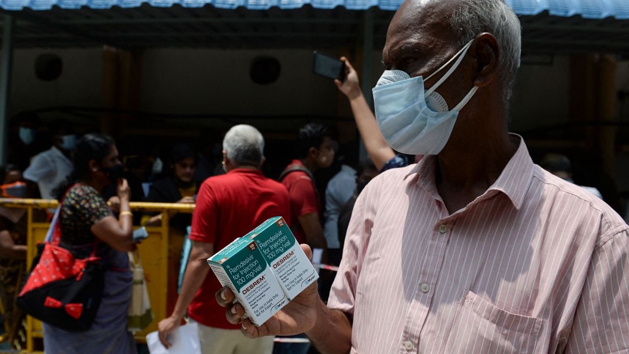 A man holds boxes of Remdesivir, an anti-viral drug used to treat Covid-19 symptoms. Credit: AFP File Photo