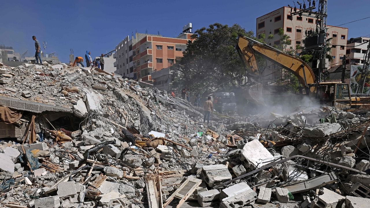 An excavator clears the rubble of a destroyed building in Gaza City's Rimal residential district on May 16, 2021, following massive Israeli bombardment on the Hamas-controlled enclave. Credit: AFP Photo