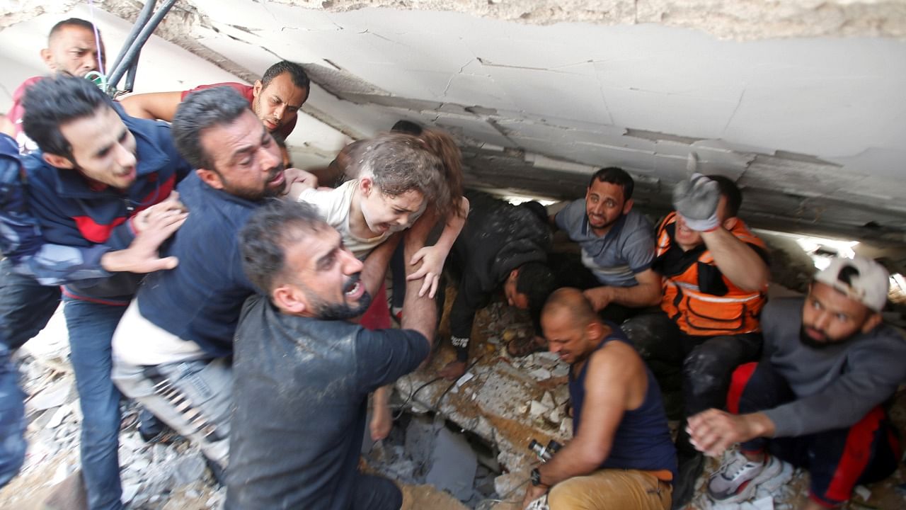 Rescuers search for victims at the site of Israeli air strikes in Gaza City. Credit: Reuters Photo
