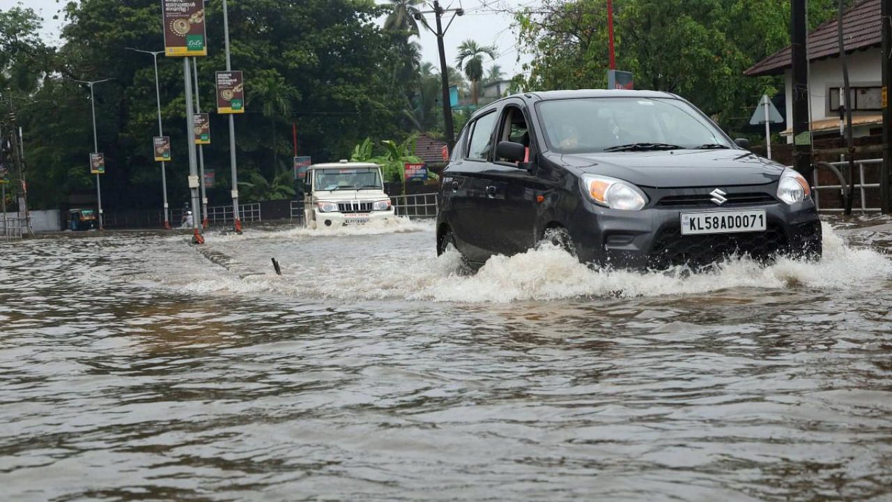Vehicles ply on a waterlogged street due to heavy rainfall owing to Cyclone Tauktae in the Arabian Sea, in Kozhikode. Credit: PTI Photo