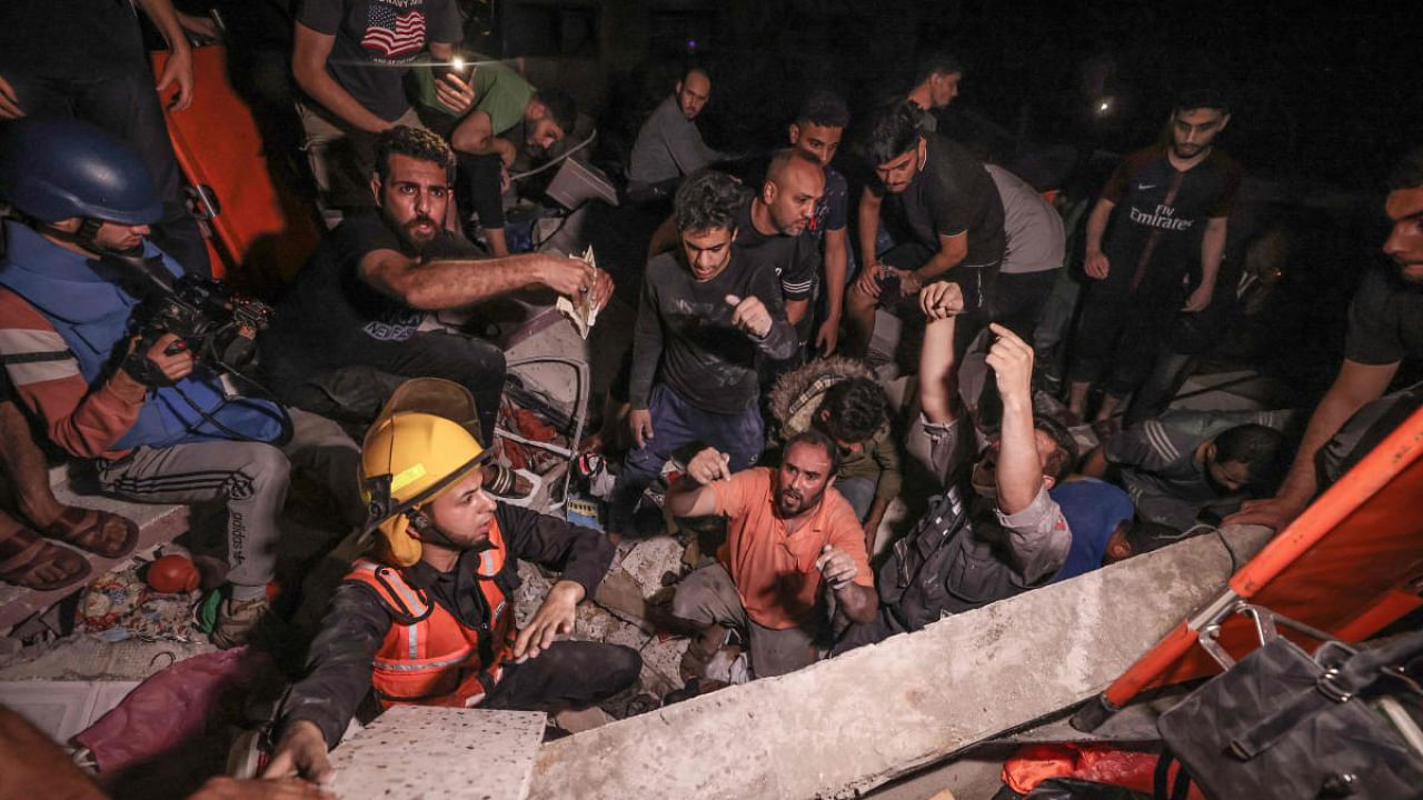 Palestinian firefighters search urgently for survivors and bodies under the rubble after an intensive civilian bombardment of Gaza. Credit: AFP Photo