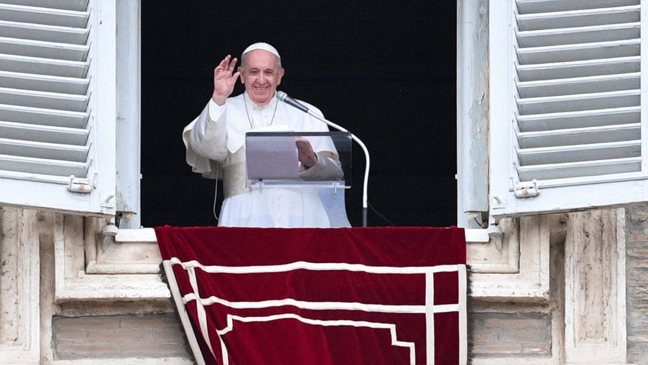 Pope Francis waves from the window of the apostolic palace overlooking St. Peter's Square, during the weekly Angelus prayer followed by the recitation of the Regina Coeli on May 16, 2021. Credit: AFP Photo