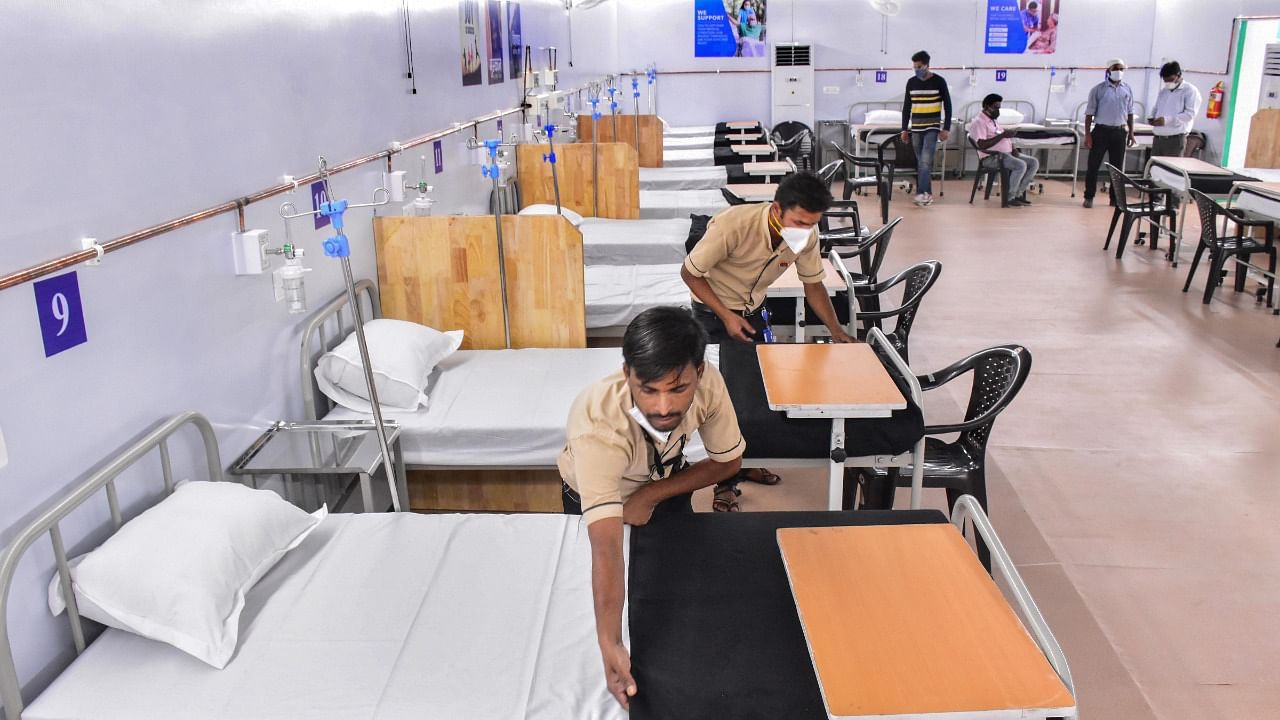 Workers arrange beds at a Covid-19 Care Center at NSCB Medical College in Jabalpur. Credit: PTI Photo