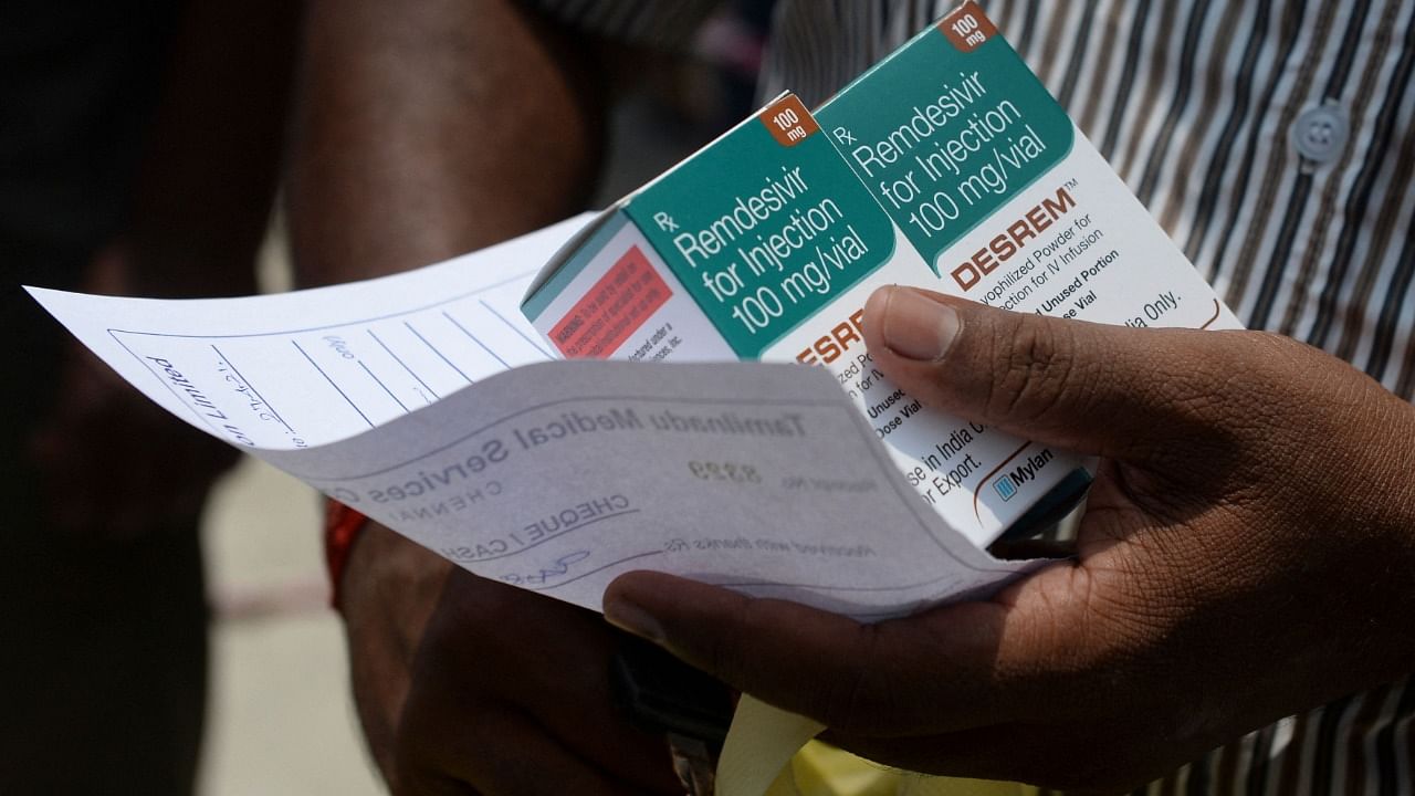 A man holds boxes of Remdesivir, an antiviral drug used to treat Covid-19 coroanavirus symptoms, purchased from government dispensary in Chennai on April 27, 2021. Credit: AFP File Photo