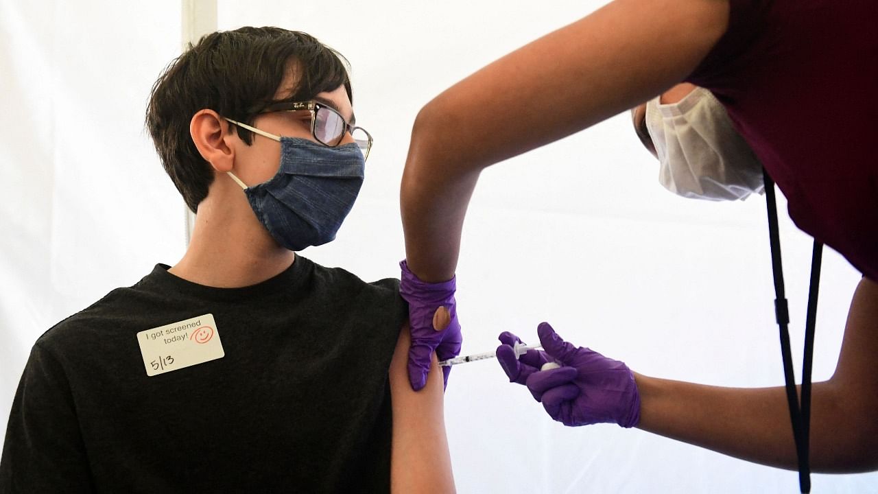 A teenager receives his first dose of the Covid-19 vaccine in the United States. Credit: AFP Photo
