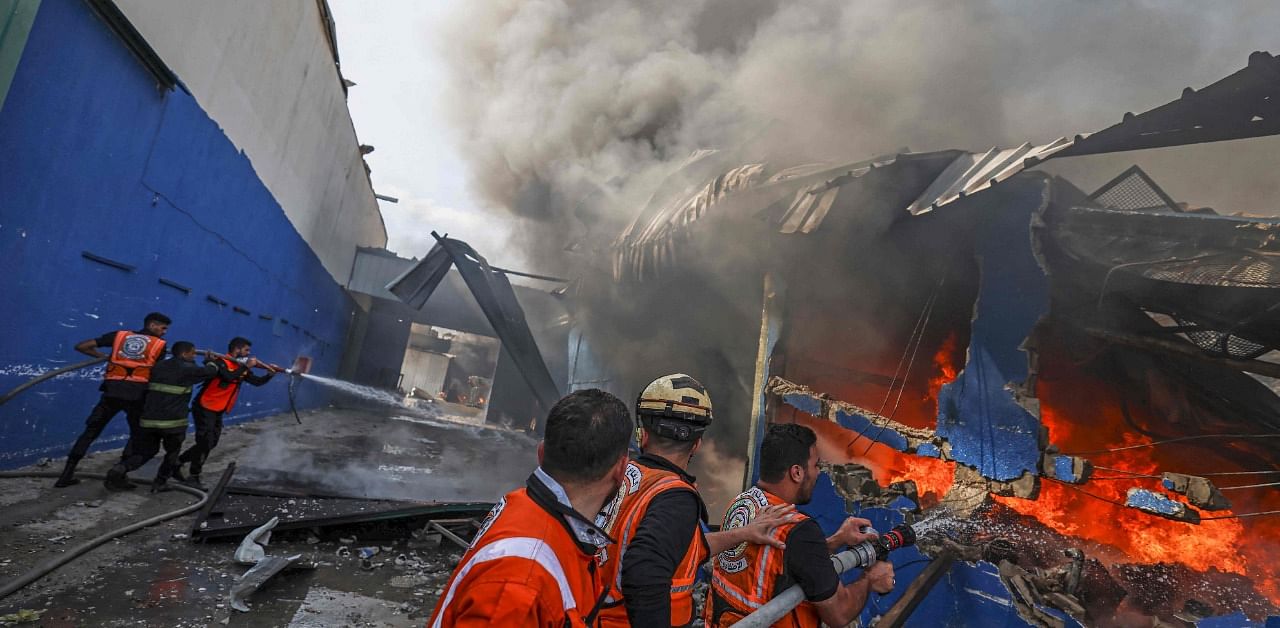 Palestinian firefighters douse a huge fire. Credit: AFP Photo