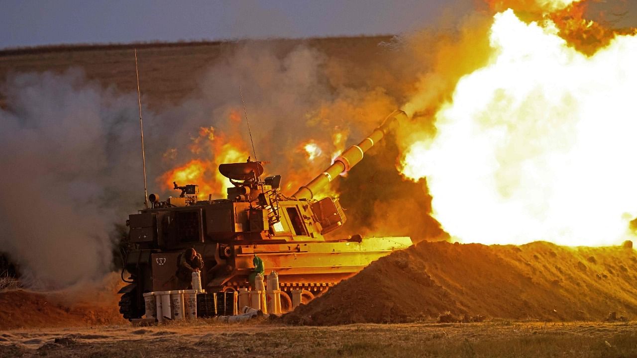 Israeli soldiers fire a 155mm self-propelled howitzer towards the Gaza Strip from their position along the border with the Palestinian enclave, on May 17, 2021. Credit: AFP Photo