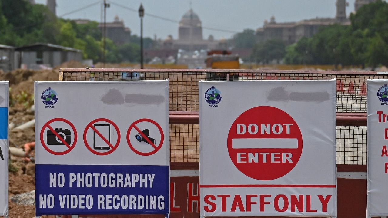 Multiple notices can seen seen placed next to redevelopment site of the Central Vista Avenue by Central Public Work Department (CPWD) along the Rajpath road in New Delhi. Credit: AFP Photo