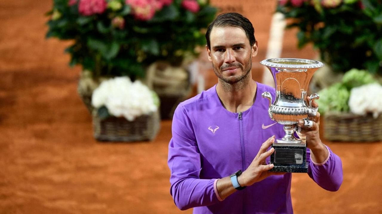 Spain's Rafael Nadal poses with the winner's trophy after defeating Serbia's Novak Djokovic during the final of the Men's Italian Tennis Open at Foro Italico. Credit: AFP Photo