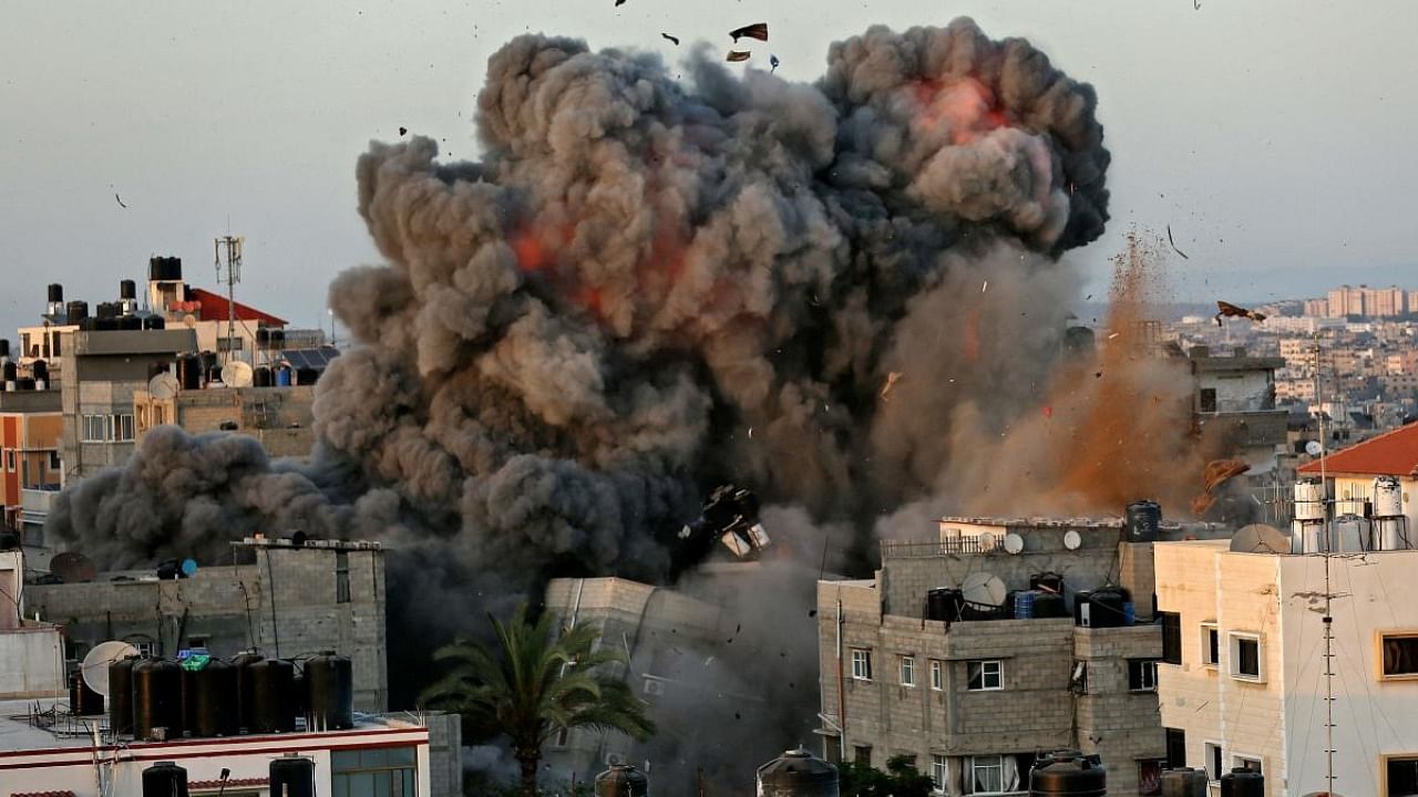 A ball of fire and thick smoke erupts from a building in Gaza City's Rimal residential district during massive Israeli bombardment on the Hamas-controlled enclave. Credit: AFP Photo