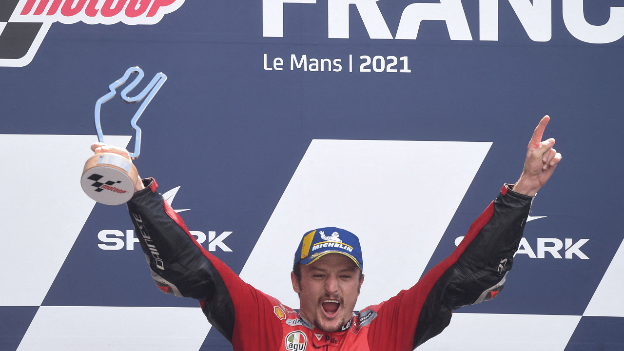 Australia's Ducati rider Jack Miller celebrates on the podium after winning the French MotoGP. Credit: AFP Photo