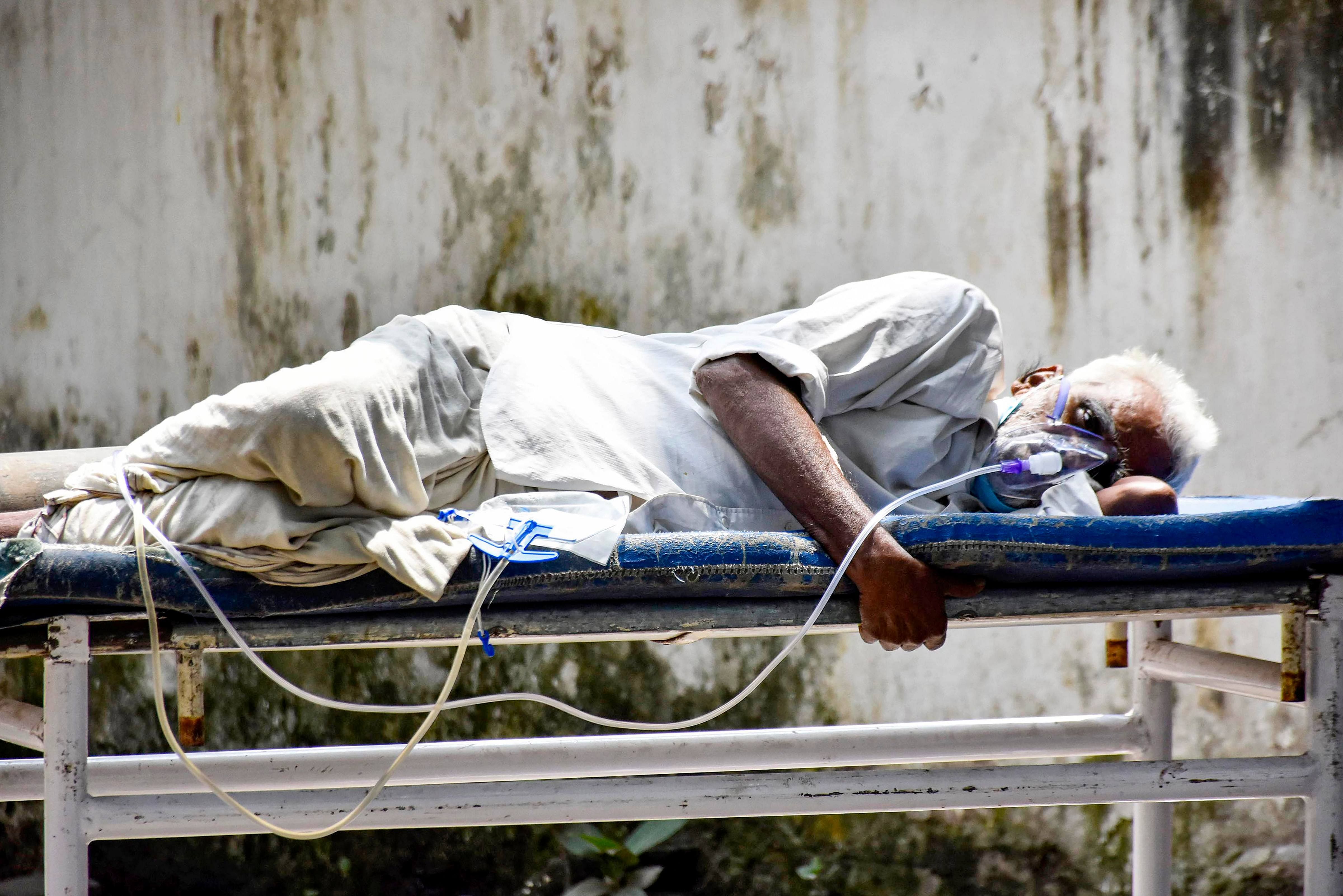 A COVID-19 patient on oxygen support waits to be admitted at Patna Medical College and Hospital. Credit: PTI