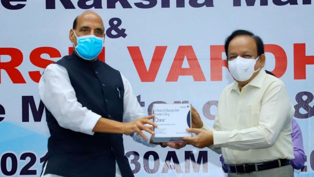 Union Defence Minister Rajnath Singh hands over to Health Minister Harsh Vardhan the newly launched anti-Covid drug 2DG, developed by DRDO, in New Delhi. Credit: PTI Photo