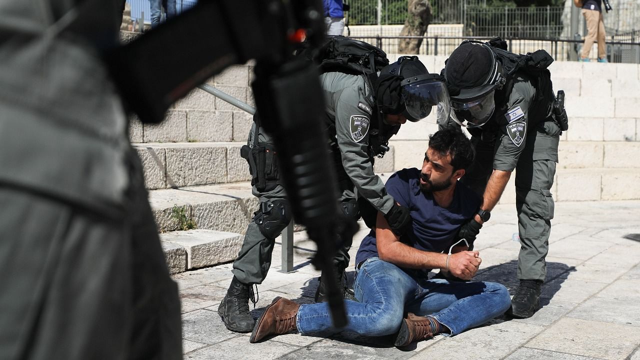 Israeli security force members detain a protester during a demonstration held by Palestinians to show their solidarity amid Israel-Gaza fighting, in Jerusalem's Old City, May 18, 2021. Credit: Reuters Photo