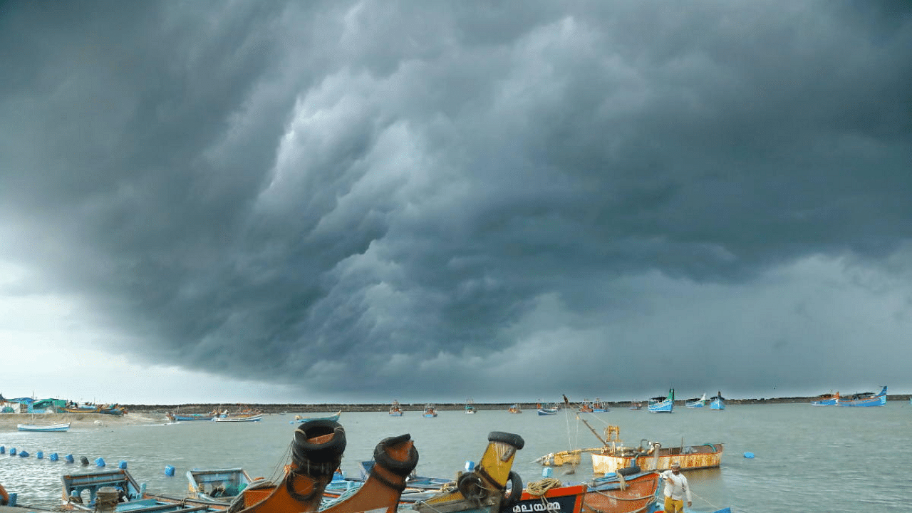 Dark clouds cover the sky during cyclone Tauktae at Vellayil Harbor in Kozhikode. Credit: PTI Photo