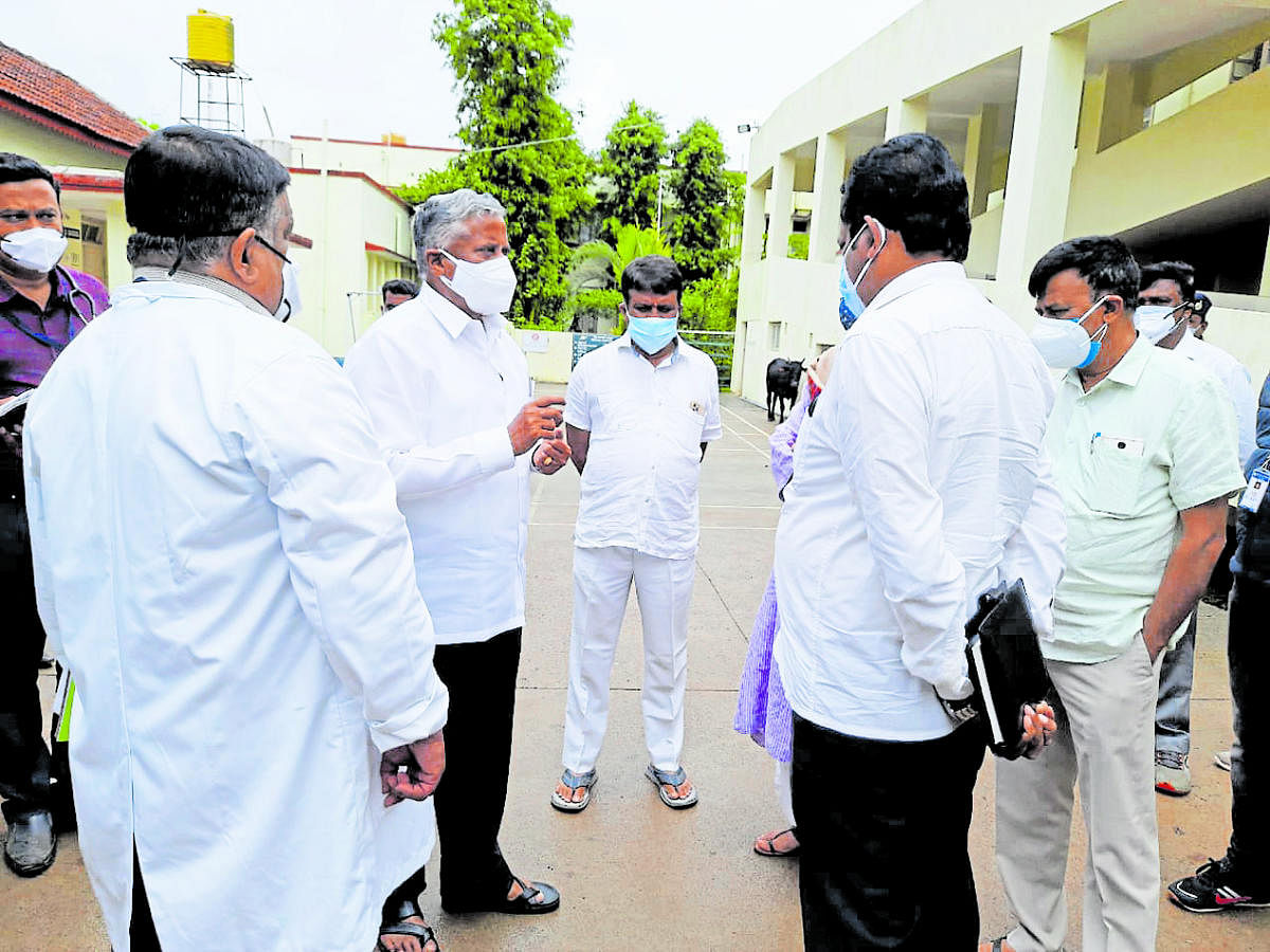 District In-charge Minister V Somanna holds a discussion with health officials in Madikeri.