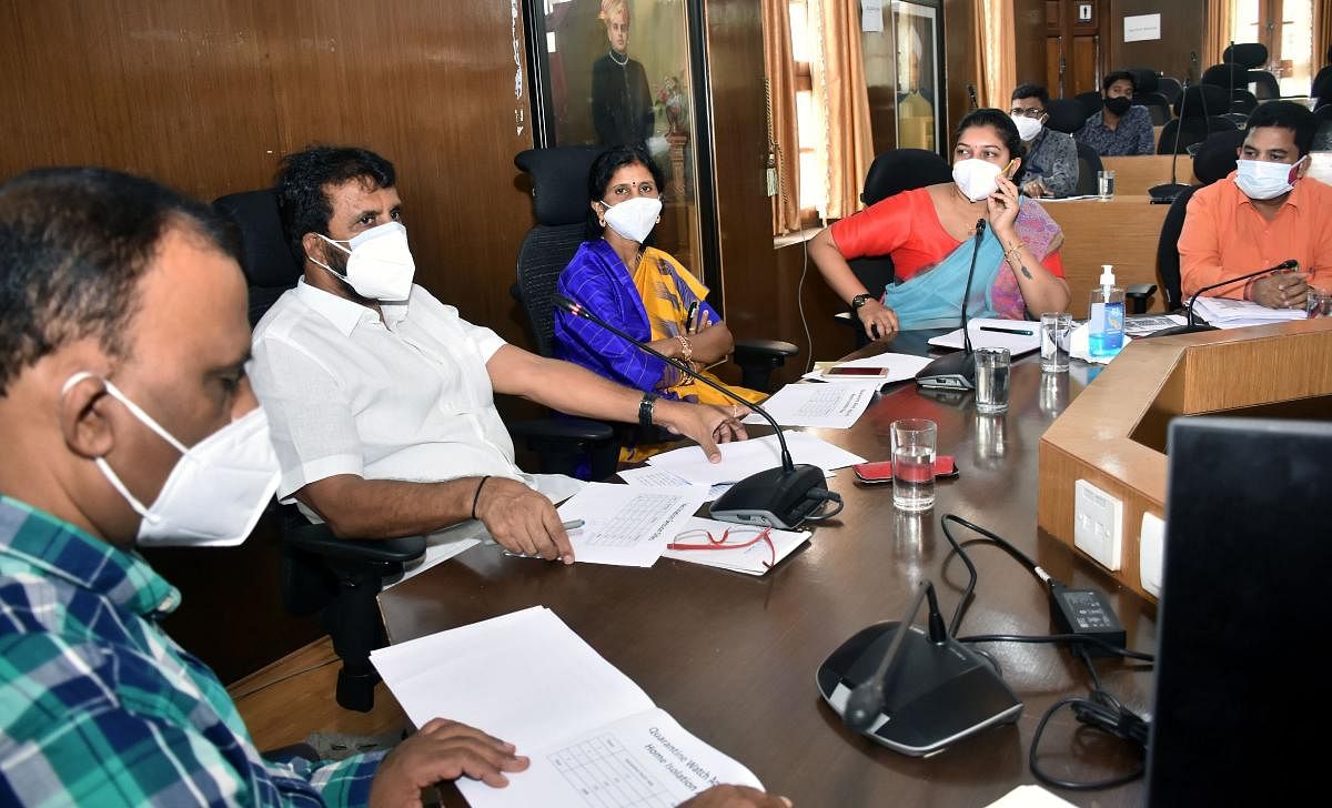 MLA L Nagendra chairs a meeting of the Chamaraja Assembly Constituency Task Force on Covid-19 in Mysuru on Monday. Health Officer of Mysuru City Corporation Dr D G Nagaraju, Mayor Rukmini Madegowda, Commissioner Shilpa Nag and District Health Officer Dr T