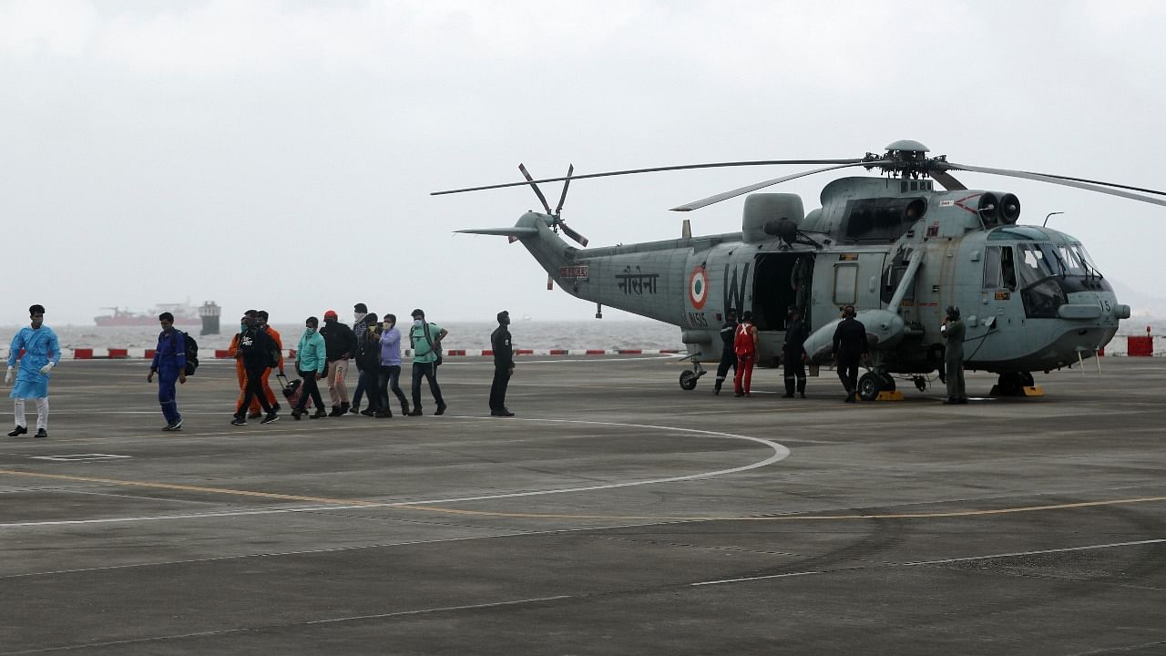 People who were stranded at sea due to Cyclone Tauktae exit an Indian Navy Sea King Mk.42C helicopter, after they were rescued by the Indian Navy. Credit: Reuters Photo