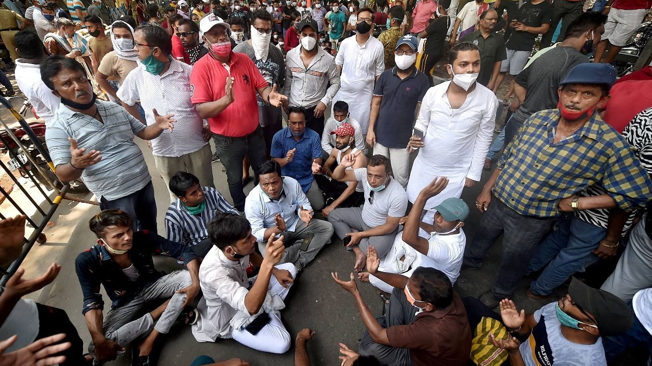 TMC activists protest outside the CBI office Nizam Palace over the arrest of party leaders in connection with the Narada scam case, in Kolkata. Credit: PTI Photo