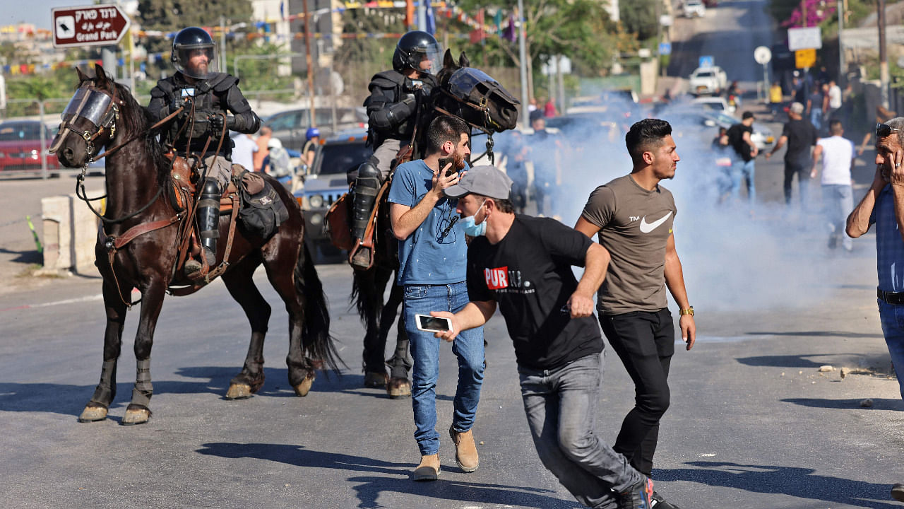 Israeli security forces on horseback disperse Palestinian demonstrators during protests against Israel's occupation and its air campaign on the Gaza strip. Credit: AFP Photo