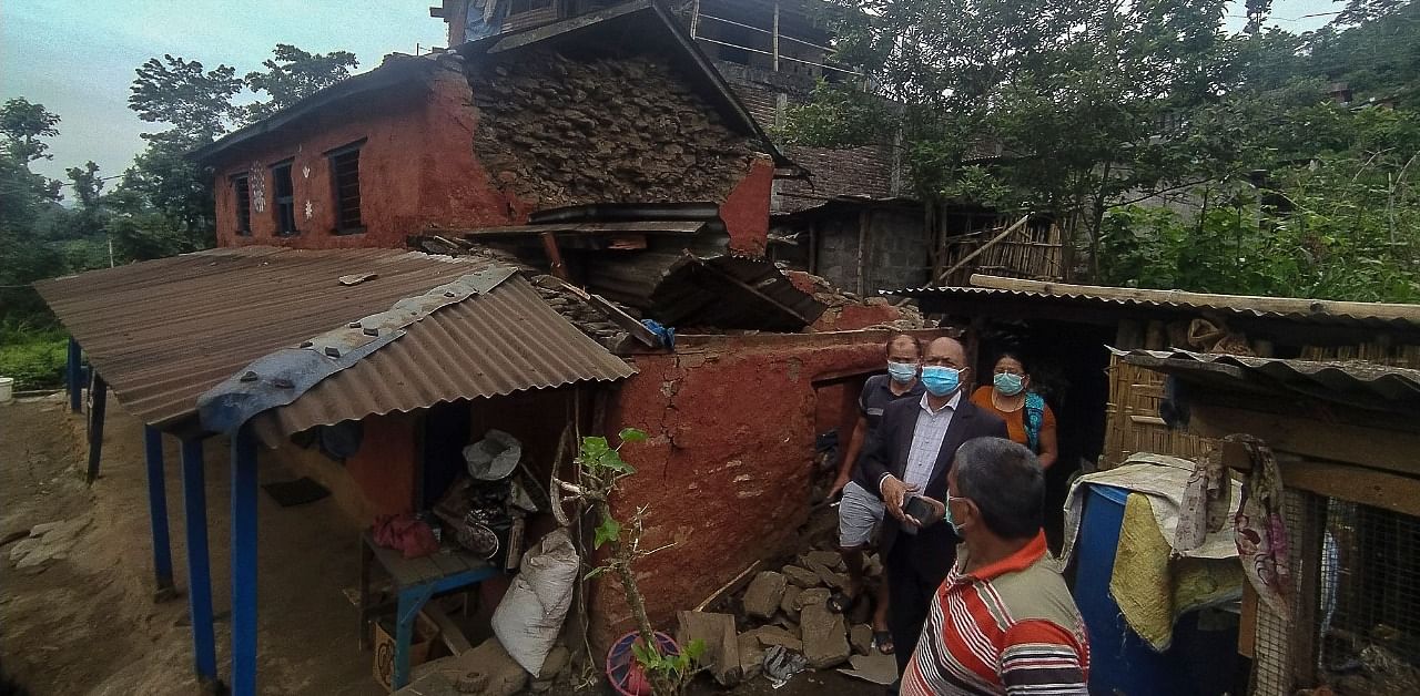 Residents gather outside a damaged house after a 5.8 magnitude earthquake hit Besisahar of Lamjung district. Credit: AFP Photo