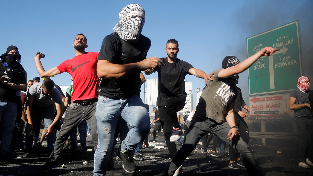 Palestinians take part in an anti-Israel protest over a cross-border violence between Palestinian militants in Gaza and the Israeli military, near Hawara checkpoint near Nablus in the Israeli-occupied West Bank. Credit: Reuters Photo