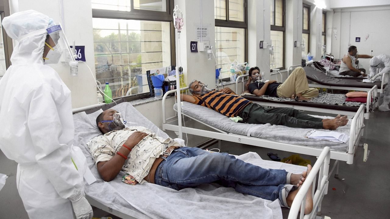 A medic looks on as patients undergo treatment at Devji Covid-19 isolation centre, during the second wave of coronavirus in Jabalpur, Saturday, May 15, 2021. Credit: PTI Photo