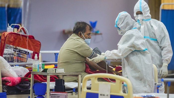 Doctors attend to a patient at a Covid care centre in Noida. Credit: PTI Photo