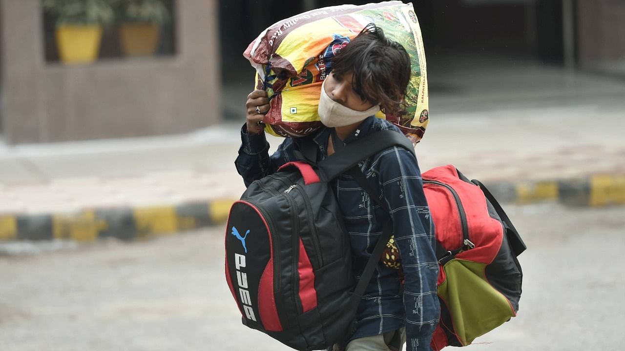 A passenger with his luggage leaves Charbagh Railway Station, during the second wave of coronavirus in Lucknow, Tuesday, May 18, 2021. Credit: PTI Photo