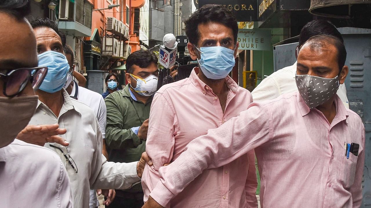 Delhi Police's Crime Branch brings Navneet Kalra for interrogation in connection with alleged black marketing of oxygen concentrators, at his Khan Chacha restaurant in New Delhi, Tuesday, May 18, 2021. Credit: PTI Photo