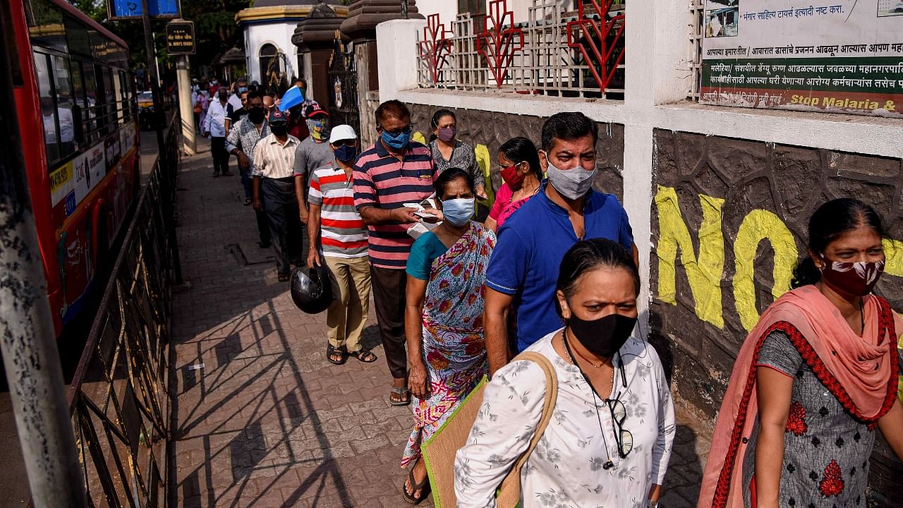 Beneficiaries stand in a queue to receive Covid-19 vaccine dose outside NMMC Hospital in Vashi. Credit: PTI Photo