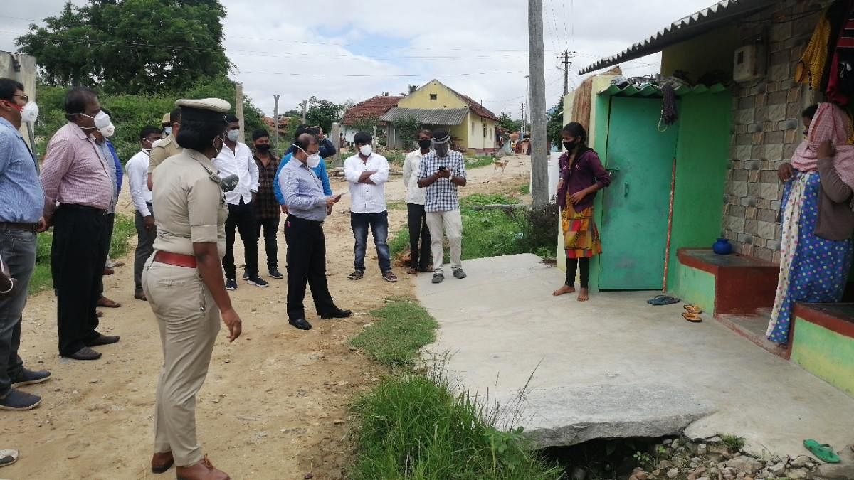 Deputy Commissioner R Girish visits Hongare village in Hassan taluk on Thursday. DH Photo